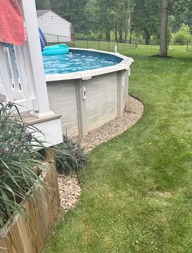 Stone landscaping border around a pool