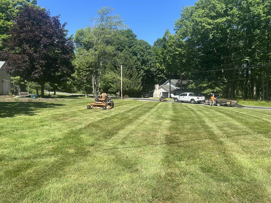Mower on a freshly striped front lawn by the driveway